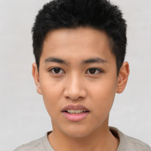 Joyful asian young-adult male with short  black hair and brown eyes