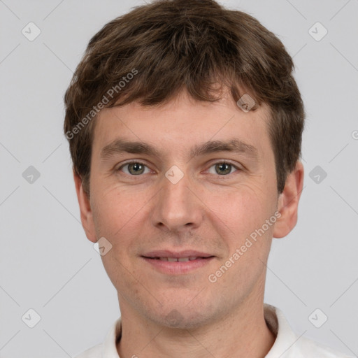 Joyful white young-adult male with short  brown hair and grey eyes