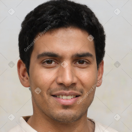 Joyful latino young-adult male with short  brown hair and brown eyes