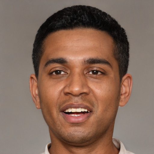 Joyful black young-adult male with short  black hair and brown eyes