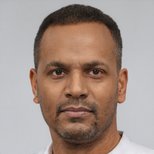 Neutral latino adult male with short  black hair and brown eyes