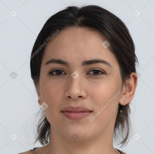 Joyful latino young-adult female with medium  brown hair and brown eyes