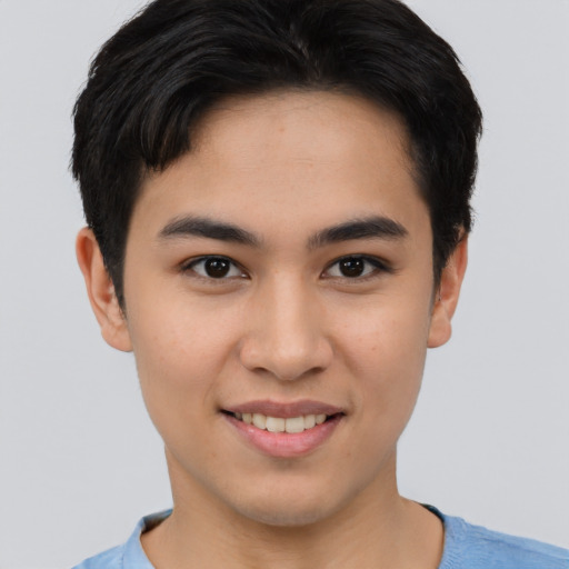 Joyful asian young-adult male with short  brown hair and brown eyes