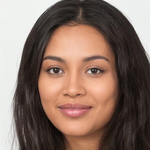 Joyful latino young-adult female with long  brown hair and brown eyes