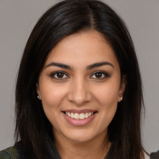 Joyful latino young-adult female with medium  brown hair and brown eyes
