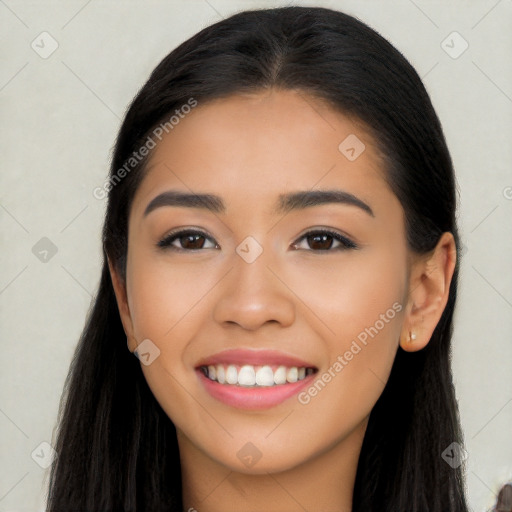 Joyful latino young-adult female with long  black hair and brown eyes