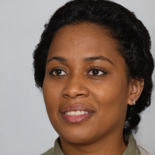 Joyful black young-adult female with medium  black hair and brown eyes