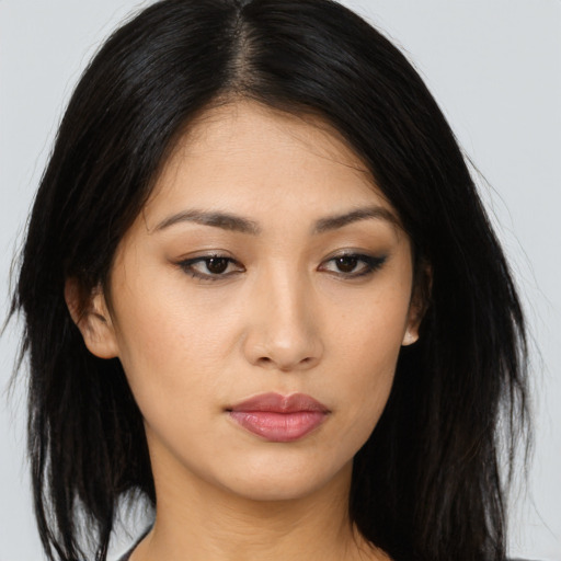 Joyful asian young-adult female with long  black hair and brown eyes