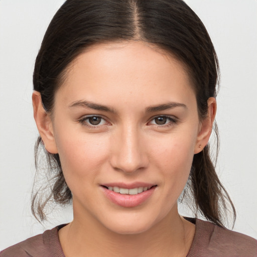 Joyful white young-adult female with medium  brown hair and brown eyes