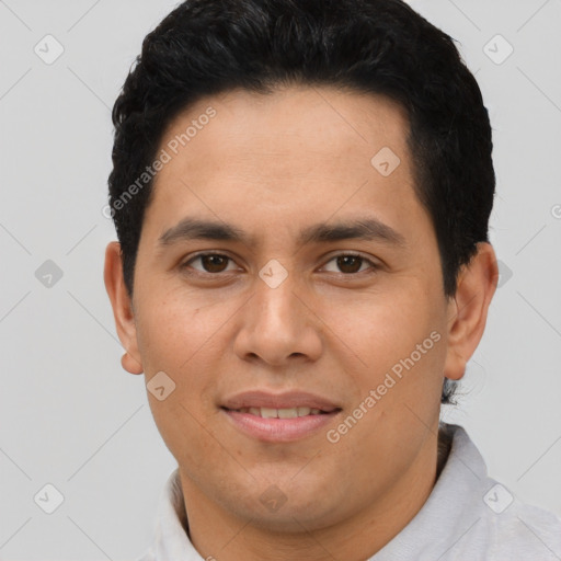 Joyful latino young-adult male with short  brown hair and brown eyes