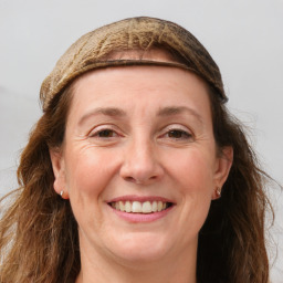 Joyful white adult female with long  brown hair and grey eyes