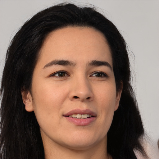 Joyful asian young-adult female with long  brown hair and brown eyes