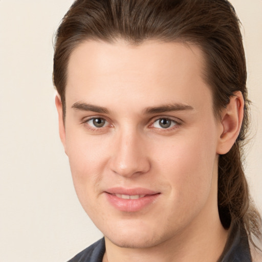 Joyful white young-adult male with medium  brown hair and brown eyes