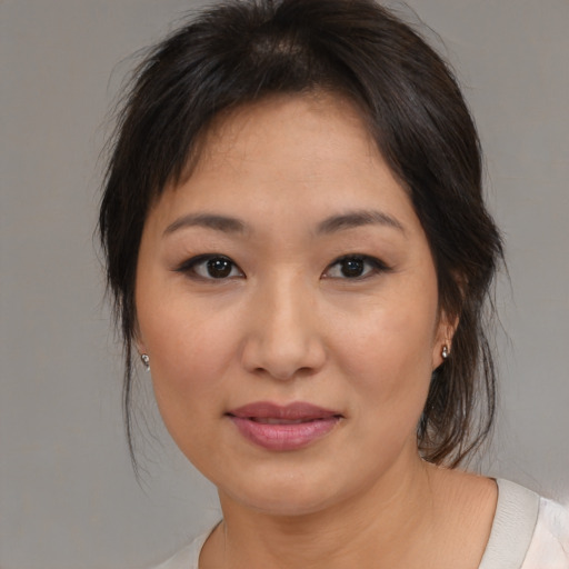 Joyful asian young-adult female with medium  brown hair and brown eyes