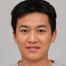 Joyful asian young-adult male with short  black hair and brown eyes