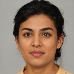 Joyful latino young-adult female with short  brown hair and brown eyes