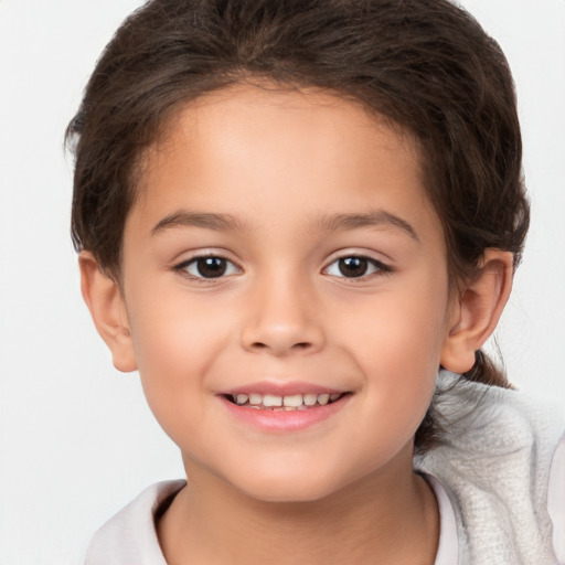 Joyful white child female with short  brown hair and brown eyes