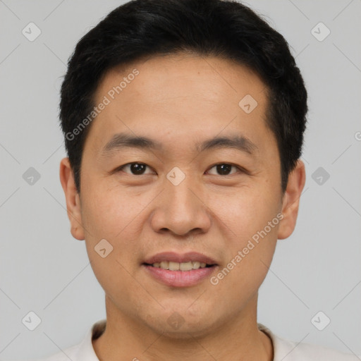 Joyful asian young-adult male with short  black hair and brown eyes