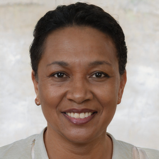 Joyful black adult female with short  brown hair and brown eyes