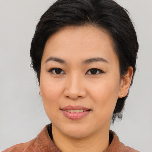 Joyful asian young-adult female with medium  brown hair and brown eyes