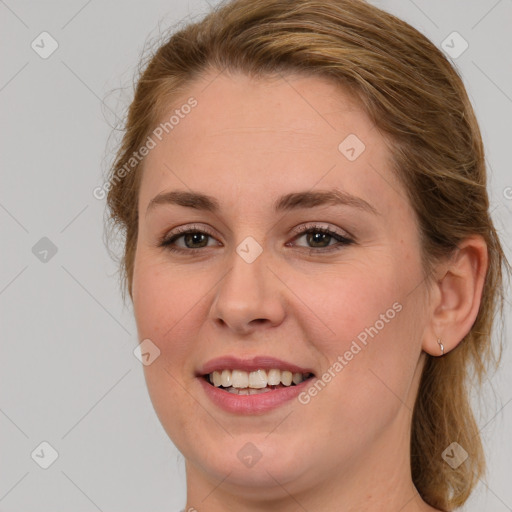 Joyful white young-adult female with medium  brown hair and green eyes