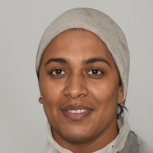 Joyful black adult female with short  black hair and brown eyes