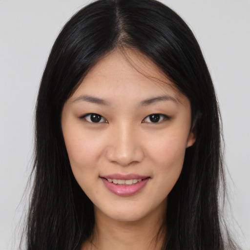 Joyful asian young-adult female with long  brown hair and brown eyes