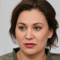 Joyful white adult female with medium  brown hair and brown eyes