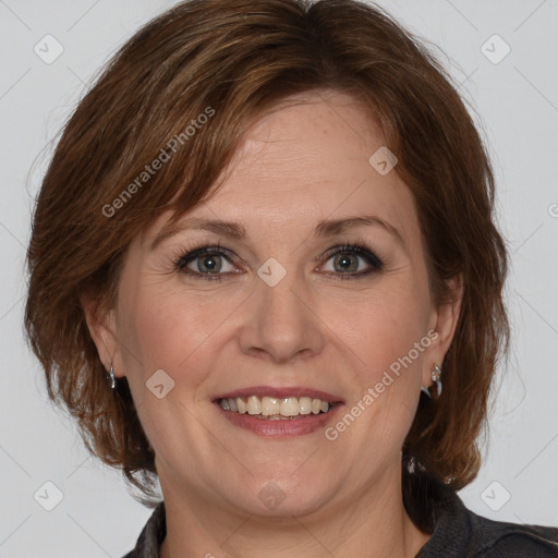 Joyful white adult female with medium  brown hair and grey eyes