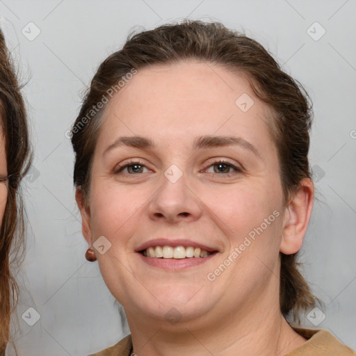 Joyful white adult female with medium  brown hair and brown eyes