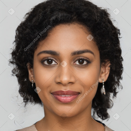 Joyful black young-adult female with long  black hair and brown eyes