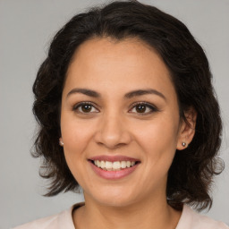 Joyful latino young-adult female with medium  brown hair and brown eyes