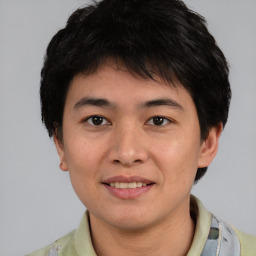 Joyful white young-adult male with short  black hair and brown eyes