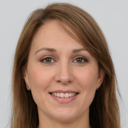 Joyful white young-adult female with long  brown hair and grey eyes