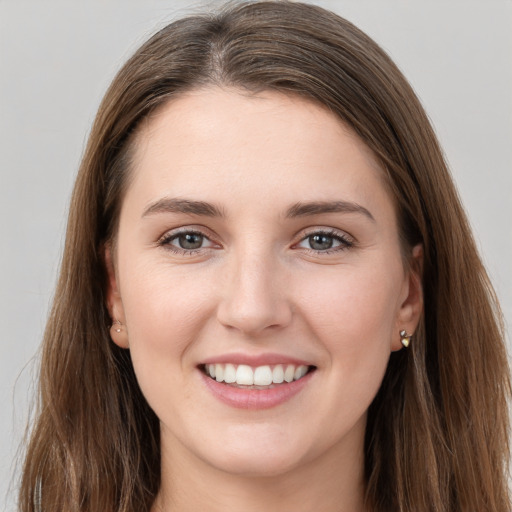 Joyful white young-adult female with long  brown hair and grey eyes