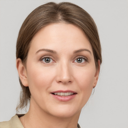 Joyful white young-adult female with medium  brown hair and grey eyes