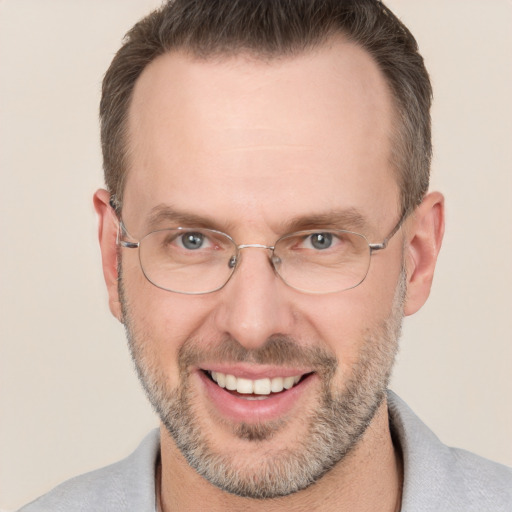 Joyful white adult male with short  brown hair and brown eyes