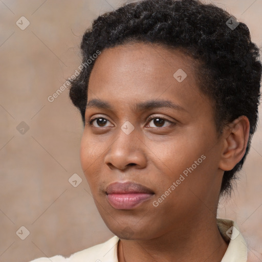 Joyful black young-adult female with short  black hair and brown eyes