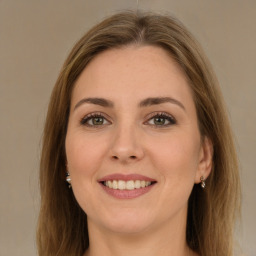 Joyful white young-adult female with long  brown hair and green eyes