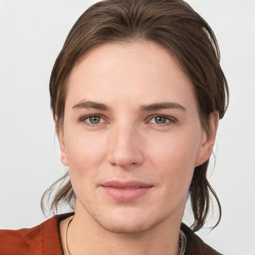 Joyful white young-adult female with medium  brown hair and grey eyes