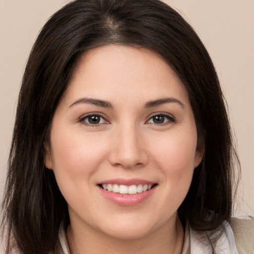 Joyful white young-adult female with medium  brown hair and brown eyes