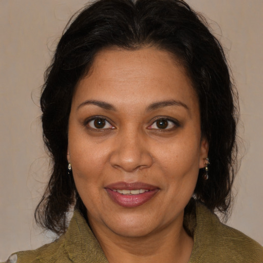 Joyful black adult female with medium  brown hair and brown eyes