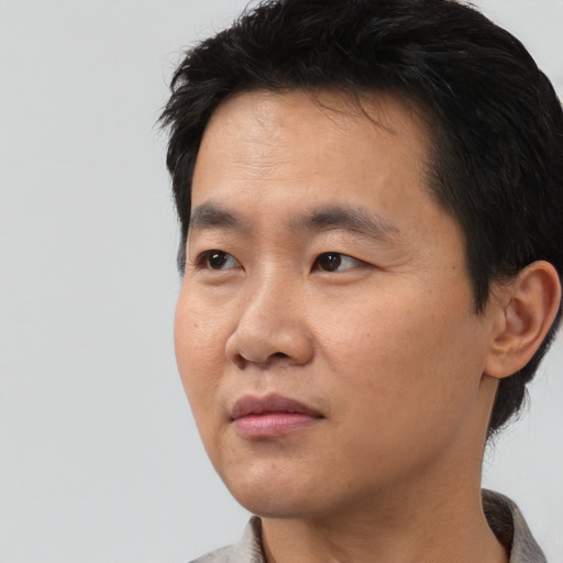 Neutral asian young-adult male with short  black hair and brown eyes