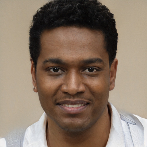 Joyful black young-adult male with short  black hair and brown eyes
