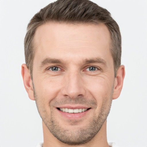 Joyful white adult male with short  brown hair and brown eyes