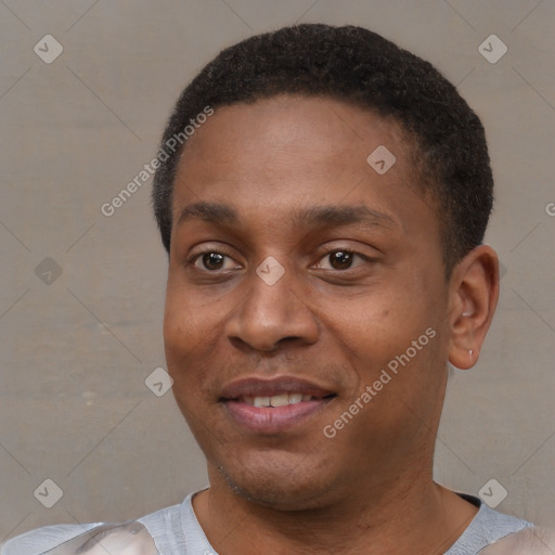 Joyful black young-adult male with short  black hair and brown eyes