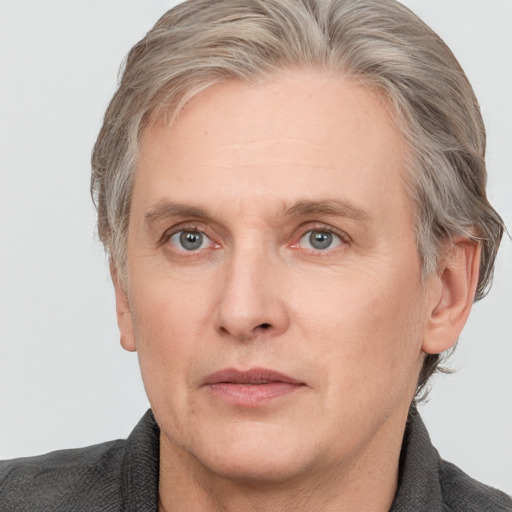 Joyful white adult male with medium  brown hair and grey eyes