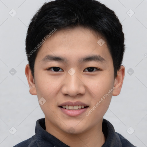 Joyful asian young-adult male with short  black hair and brown eyes