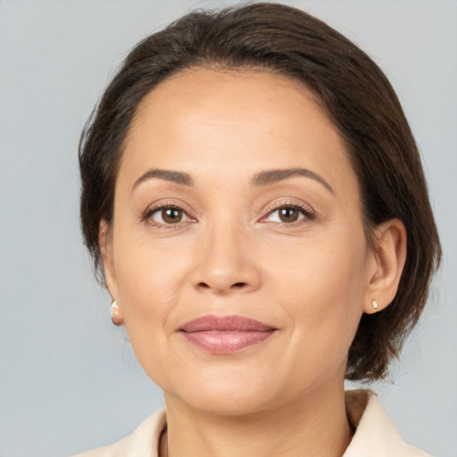 Joyful white adult female with medium  brown hair and brown eyes