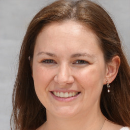 Joyful white young-adult female with medium  brown hair and grey eyes